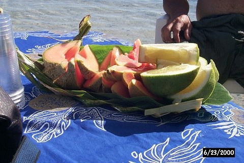 Handwoven palm leaf basket of fresh fruit